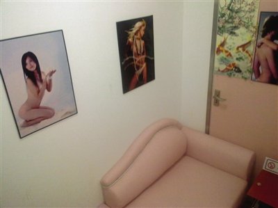 取精室內(nèi)，有一個粉色沙發(fā)，墻壁四周掛著女體畫